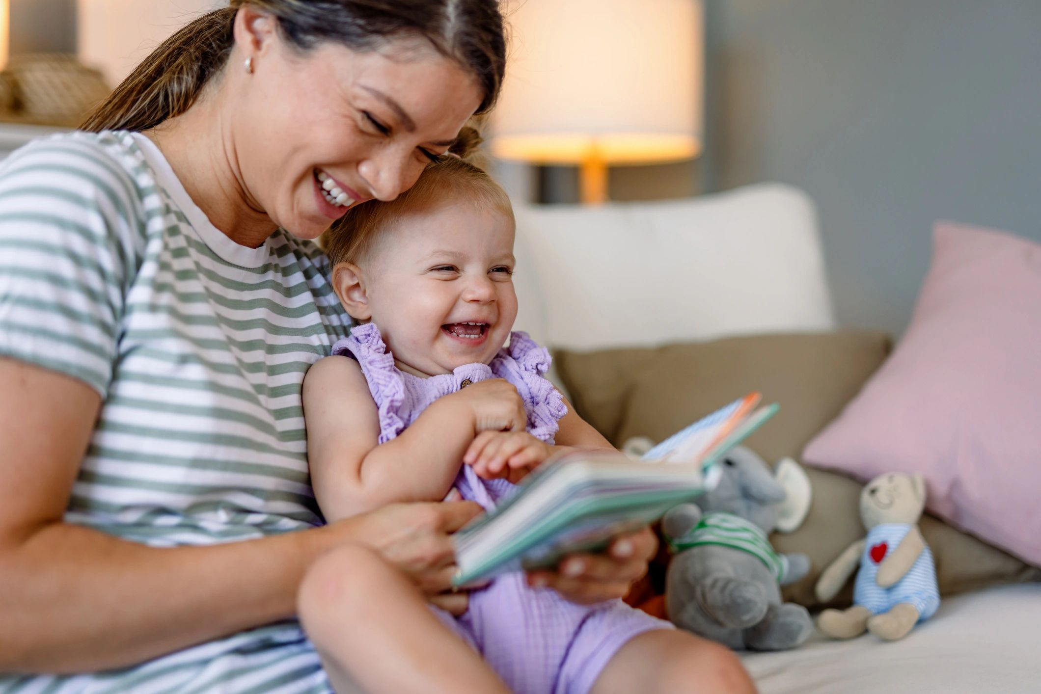 Parent and child laughing while reading